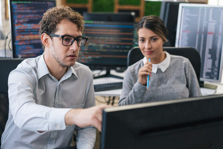 Software programmers analyzing html code and database, brainstorming script ideas to develop new security system. Engineers working with coding language collaborating on group project.