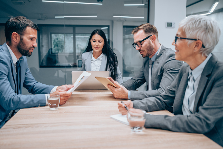 Group of business persons in business meeting. Group of entrepreneurs on meeting in board room. Corporate business team on meeting in the office.